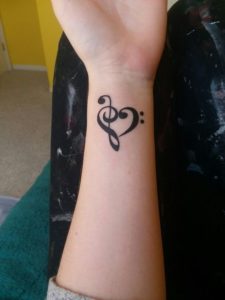 musical note wrist and hand tattoo for girls